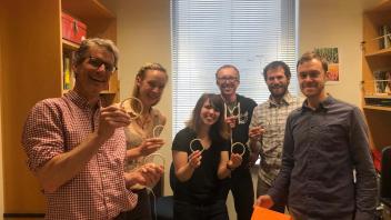 Lab members show off their ring toss skills
